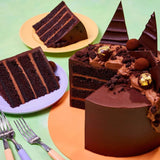 Ultimate Chocolate Cake with four layers, chocolate ganache, truffles, shards, and edible gold decorations.